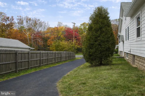 a view of a backyard with wooden fence