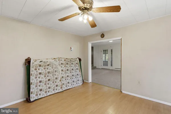 a view of a livingroom with a ceiling fan and window