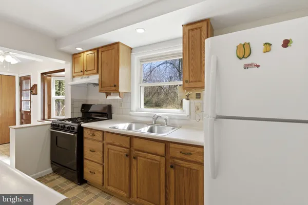a white refrigerator freezer sitting inside of a kitchen