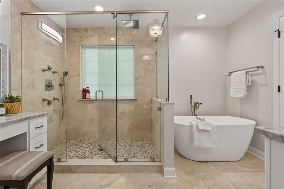 322 Shorecrest Drive Seneca, SC 29672 - Photo 15 of 30 This serene bathroom offers a spacious glass-enclosed shower and a freestanding soaking tub.