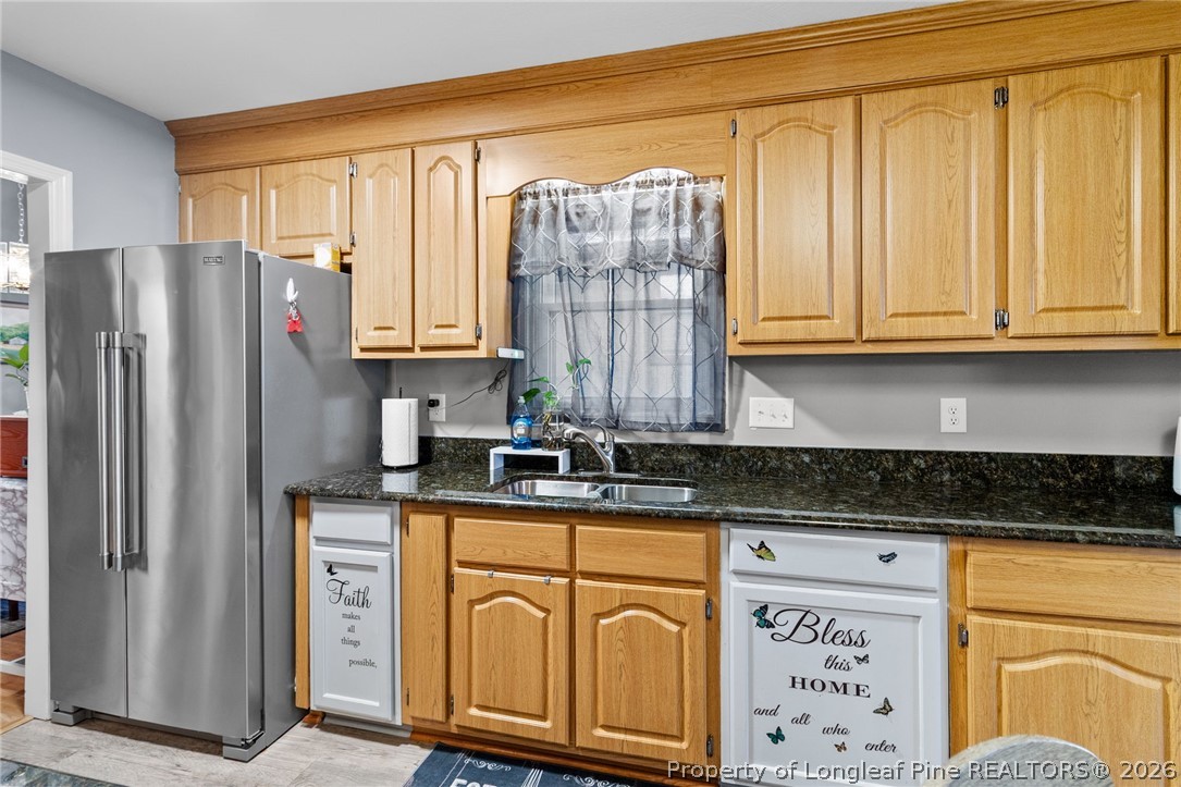 1912 Havilah Road Fayetteville, NC 28303 - Photo 6 of 14 a kitchen with stainless steel appliances granite countertop a refrigerator and a stove top oven