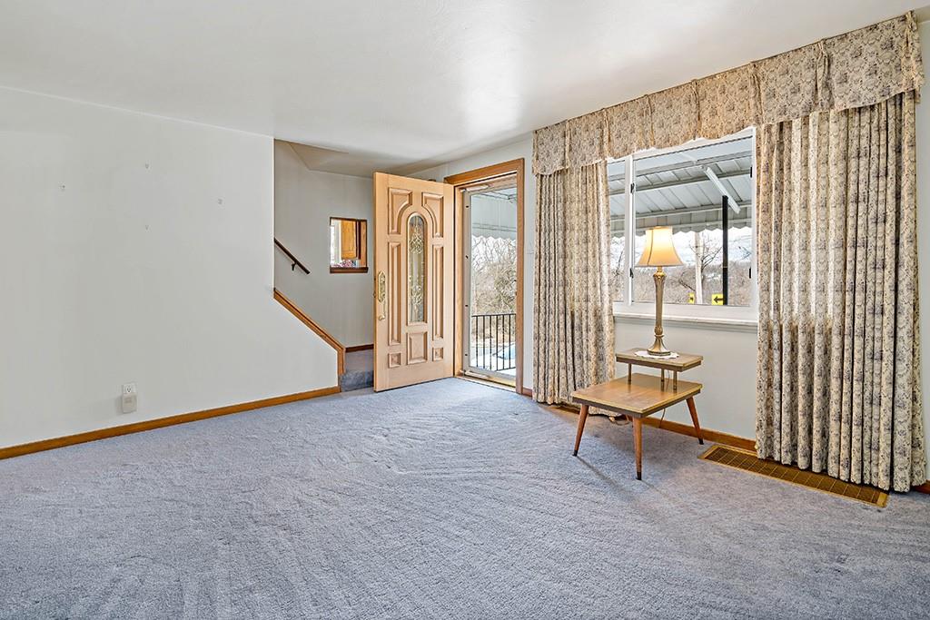 2839 Reiter Road Pittsburgh, PA 15235 - Photo 4 of 25 a view of an empty room with stairs and a window