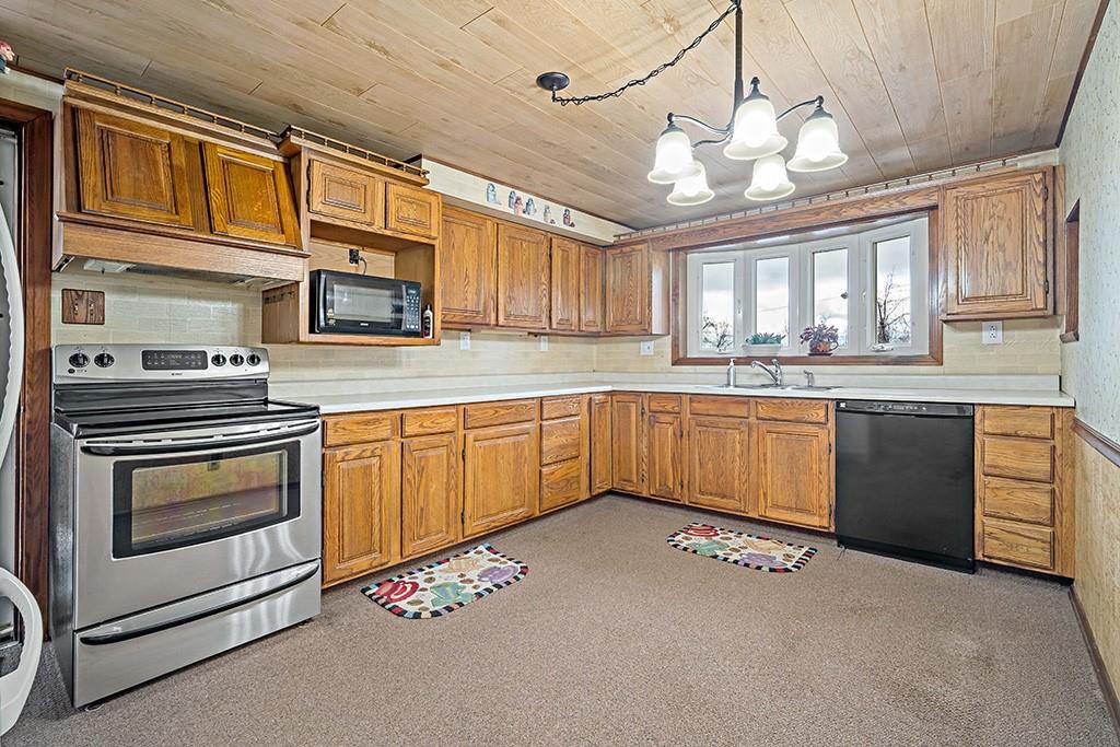 2839 Reiter Road Pittsburgh, PA 15235 - Photo 6 of 25 a kitchen with stainless steel appliances granite countertop a sink a stove a refrigerator cabinets and a window