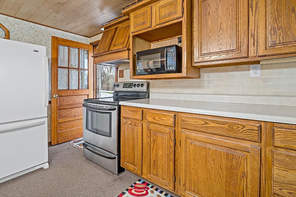 2839 Reiter Road Pittsburgh, PA 15235 - Photo 8 of 25 a kitchen with stainless steel appliances granite countertop white cabinets and a refrigerator
