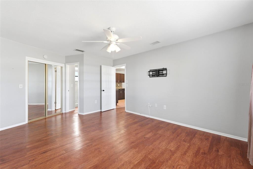 5364 Deltona Boulevard Spring Hill, FL 34606 - Photo 12 of 33 a view of an empty room with wooden floor