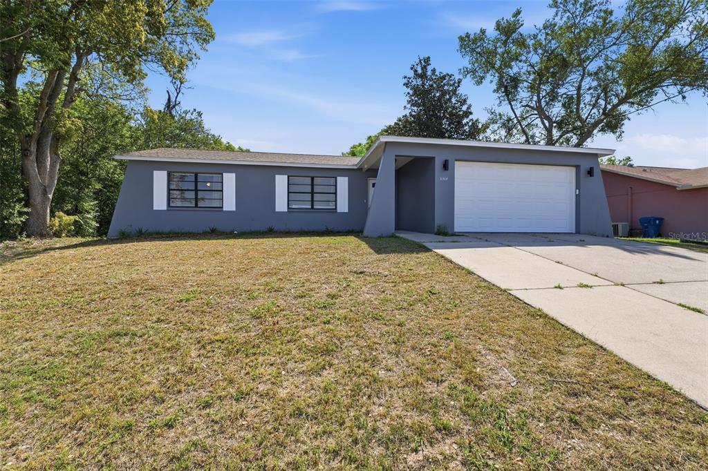 5364 Deltona Boulevard Spring Hill, FL 34606 - Photo 29 of 33 a view of a house with a yard