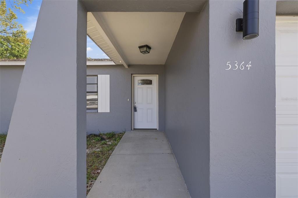 5364 Deltona Boulevard Spring Hill, FL 34606 - Photo 3 of 33 a view of a hallway with wooden walls