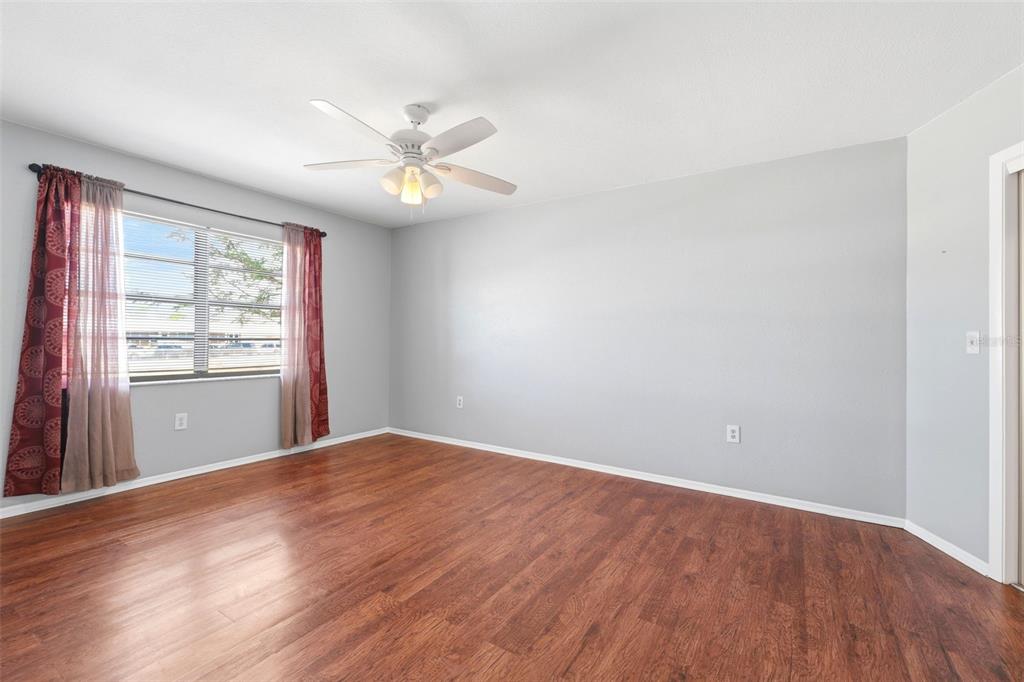 5364 Deltona Boulevard Spring Hill, FL 34606 - Photo 10 of 33 wooden floor in an empty room with a window