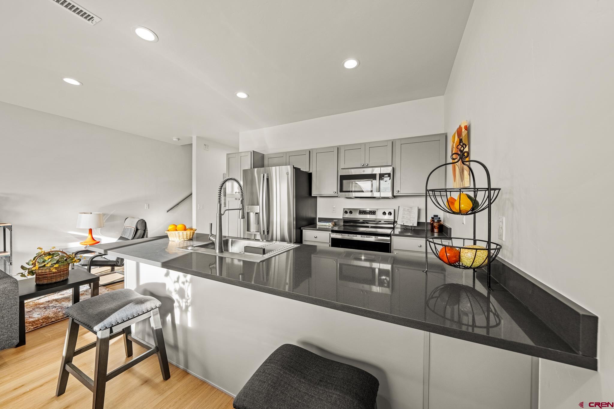 116 Senica Street Bayfield, CO 81122 - Photo 12 of 28 a kitchen with a sink a stove and chairs