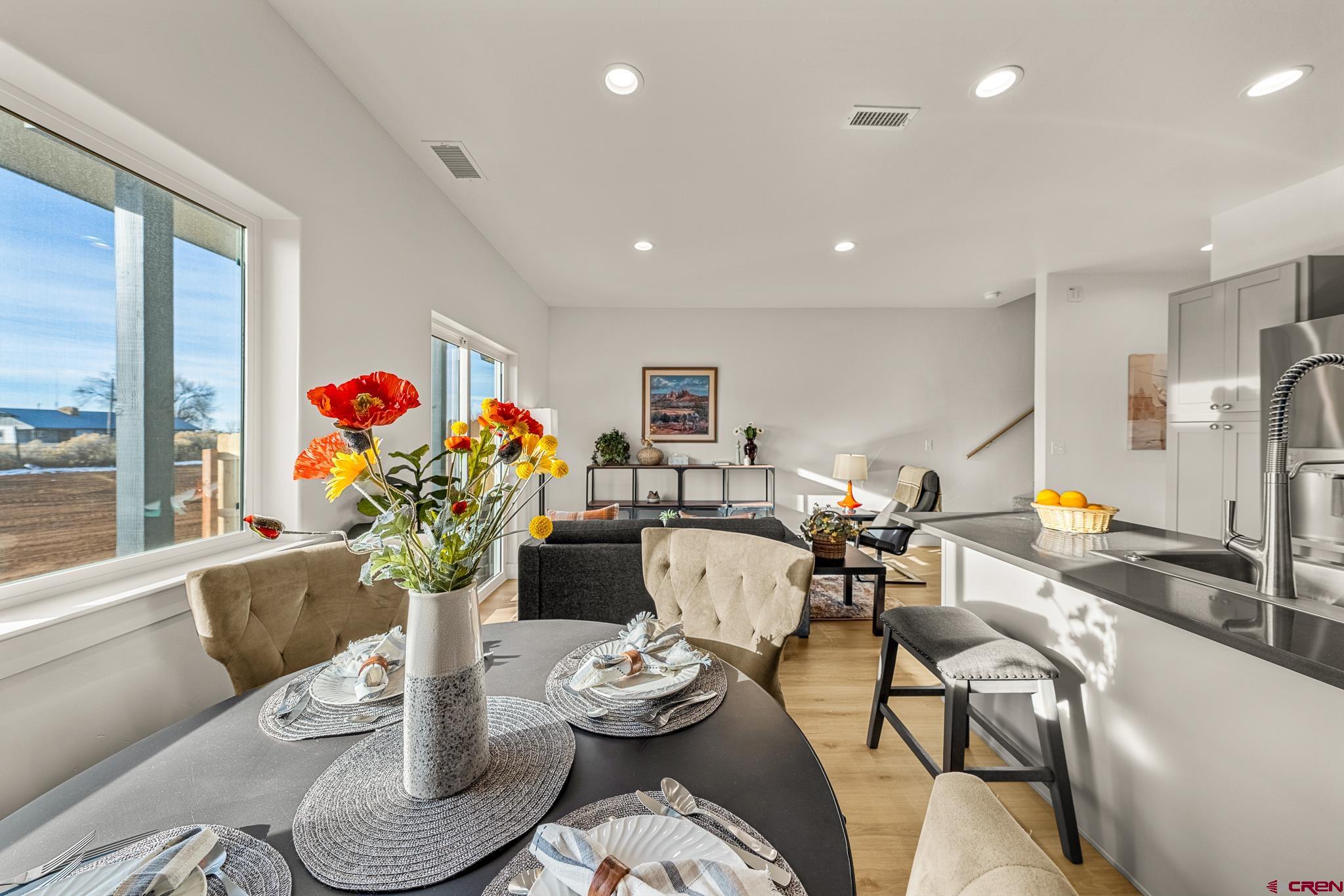 116 Senica Street Bayfield, CO 81122 - Photo 5 of 28 a living room with furniture and a dining table with wooden floor