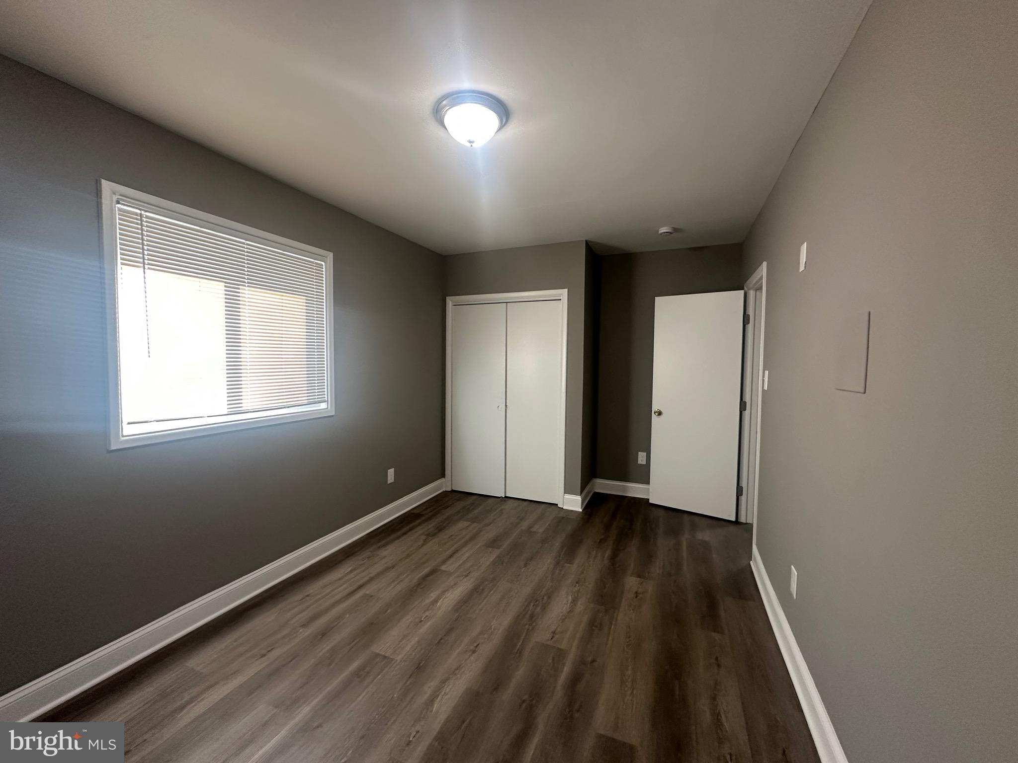 1401 Madison Drive Fort Washington, MD 20744 - Photo 18 of 30 a view of an empty room with wooden floor and a window