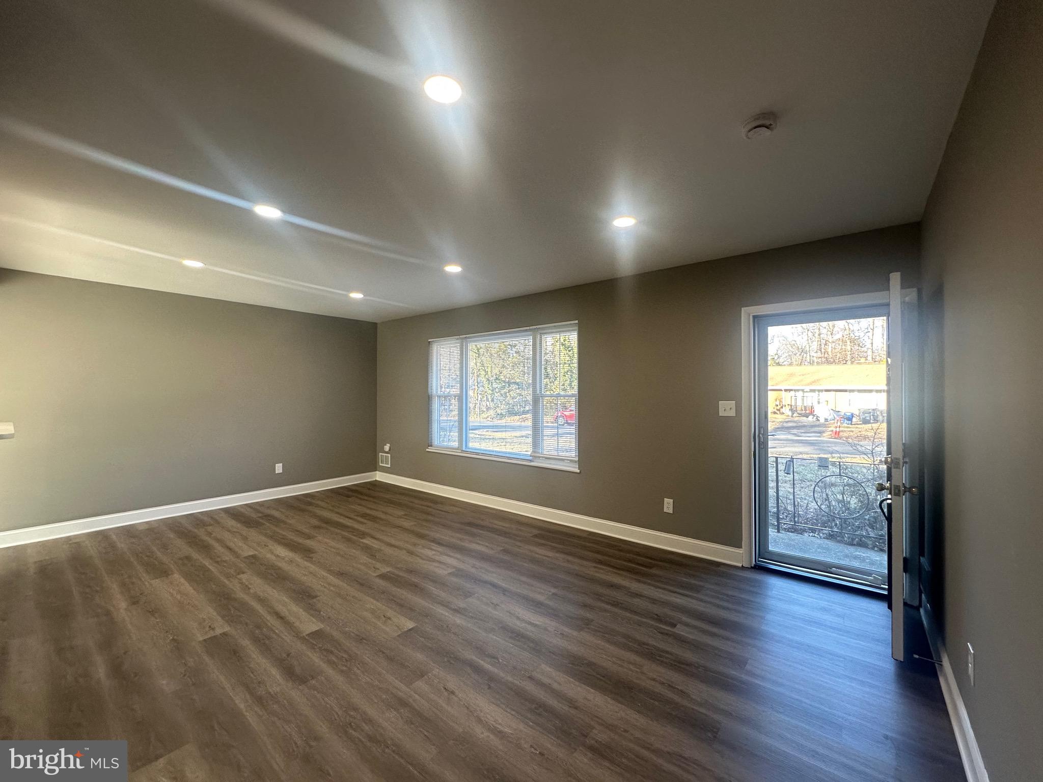 1401 Madison Drive Fort Washington, MD 20744 - Photo 2 of 30 an empty room with wooden floor and windows