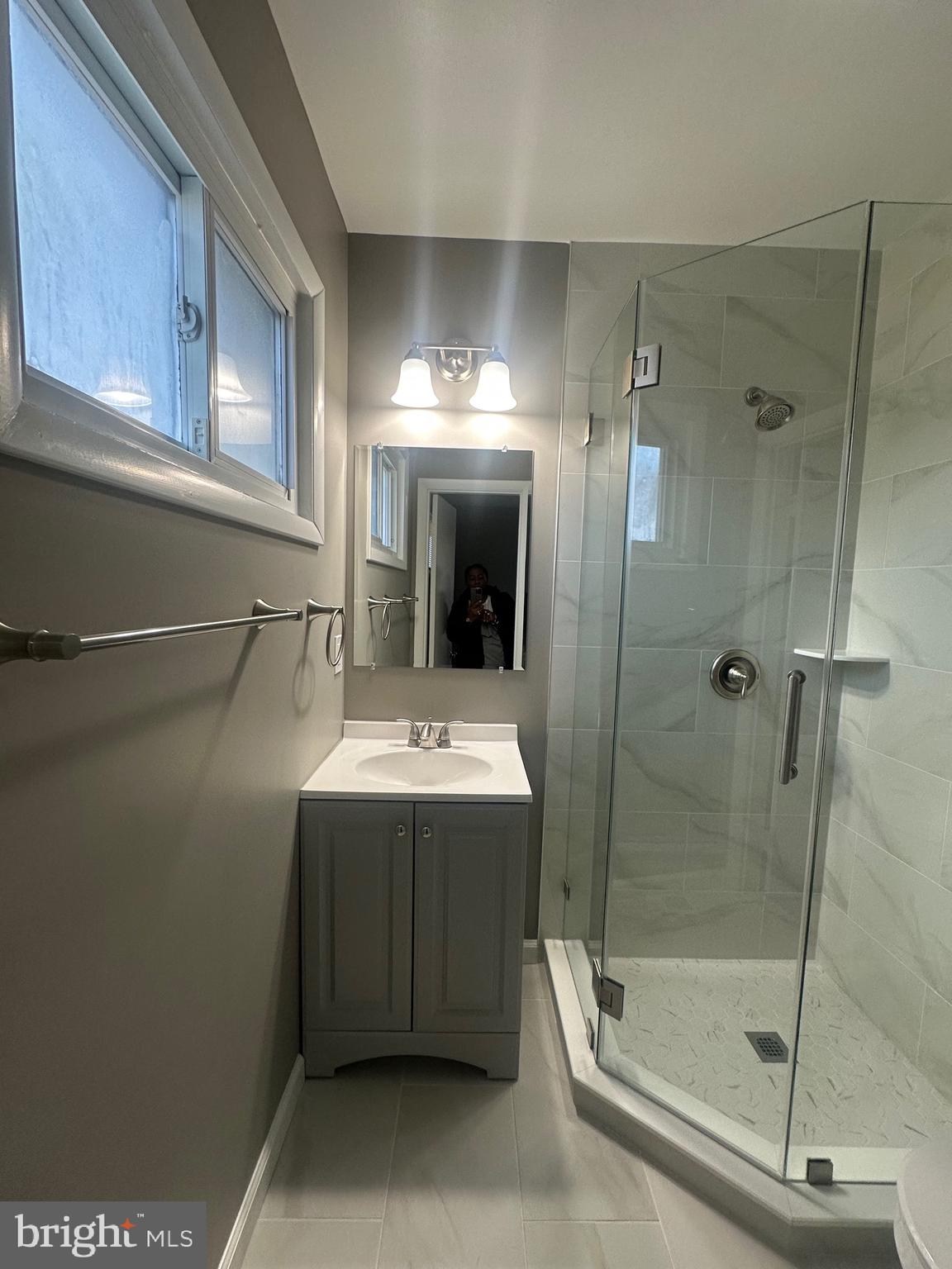 1401 Madison Drive Fort Washington, MD 20744 - Photo 22 of 30 a bathroom with a sink mirror and shower