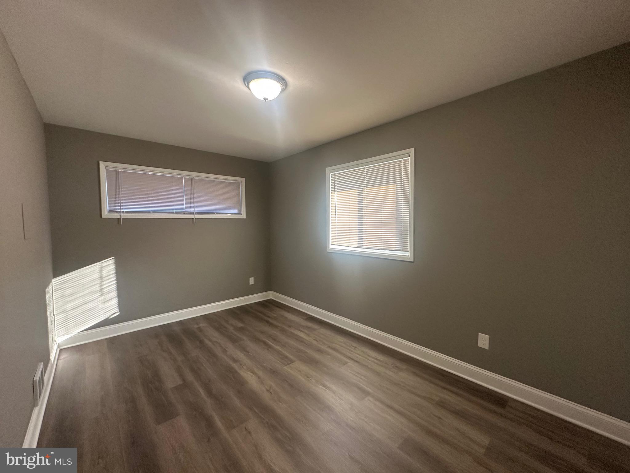 1401 Madison Drive Fort Washington, MD 20744 - Photo 23 of 30 an empty room with wooden floor and windows