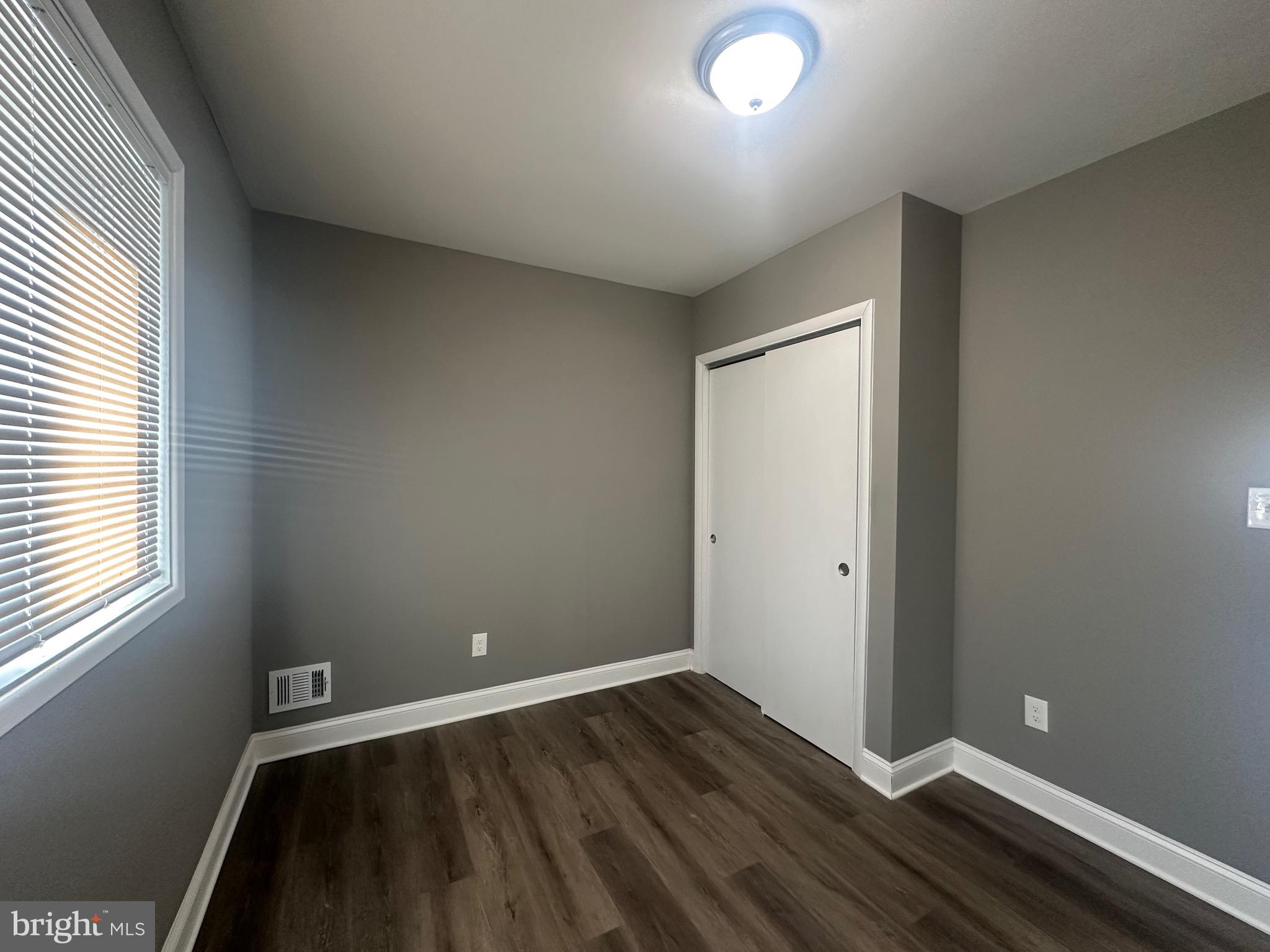1401 Madison Drive Fort Washington, MD 20744 - Photo 26 of 30 an empty room with wooden floor and windows