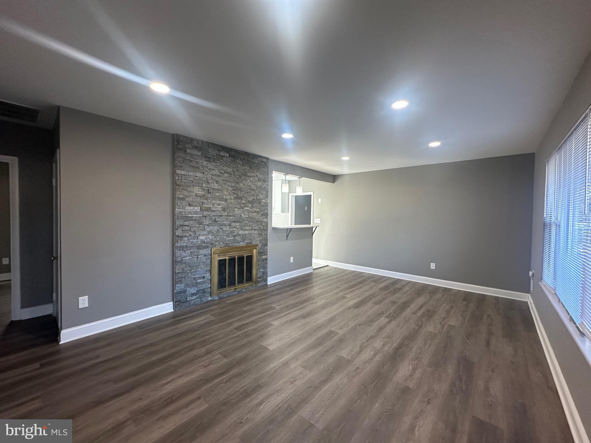 1401 Madison Drive Fort Washington, MD 20744 - Photo 3 of 30 an empty room with wooden floor and fireplace