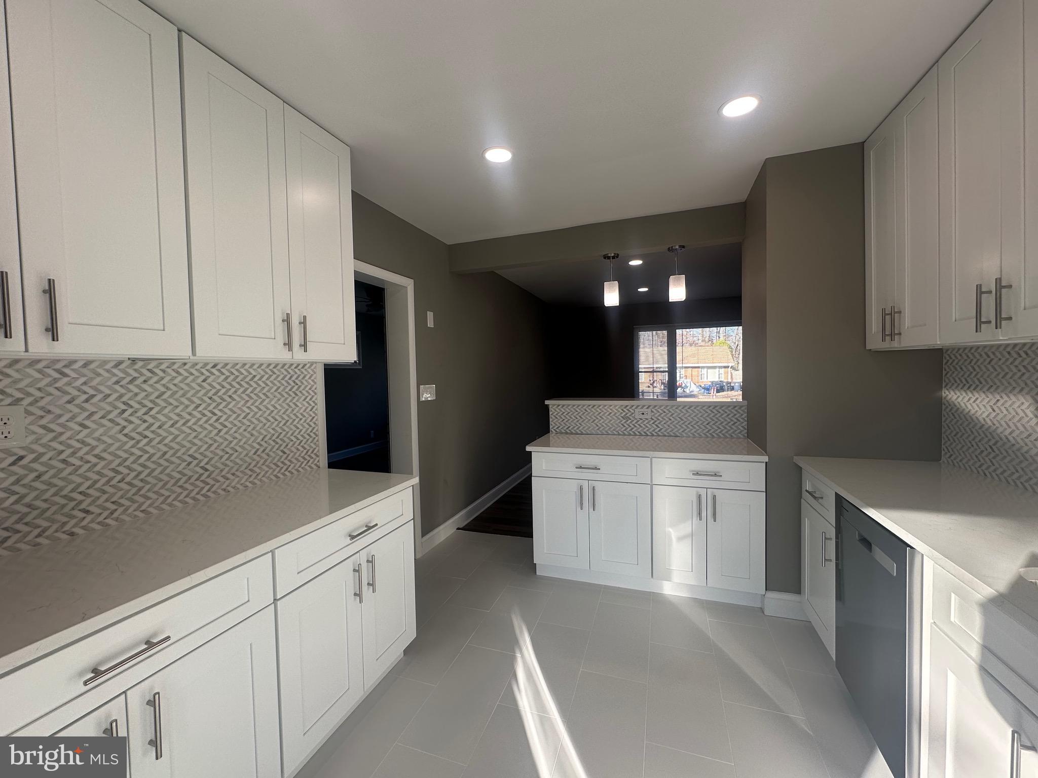 1401 Madison Drive Fort Washington, MD 20744 - Photo 6 of 30 a large kitchen with granite countertop white cabinets and stainless steel appliances
