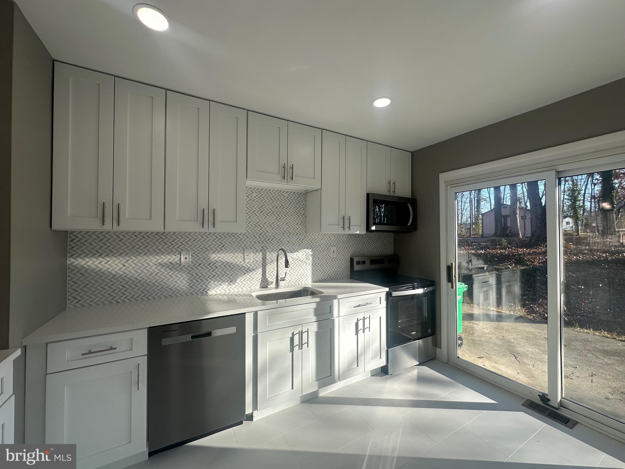 1401 Madison Drive Fort Washington, MD 20744 - Photo 9 of 30 a kitchen with a sink stainless steel appliances and cabinets