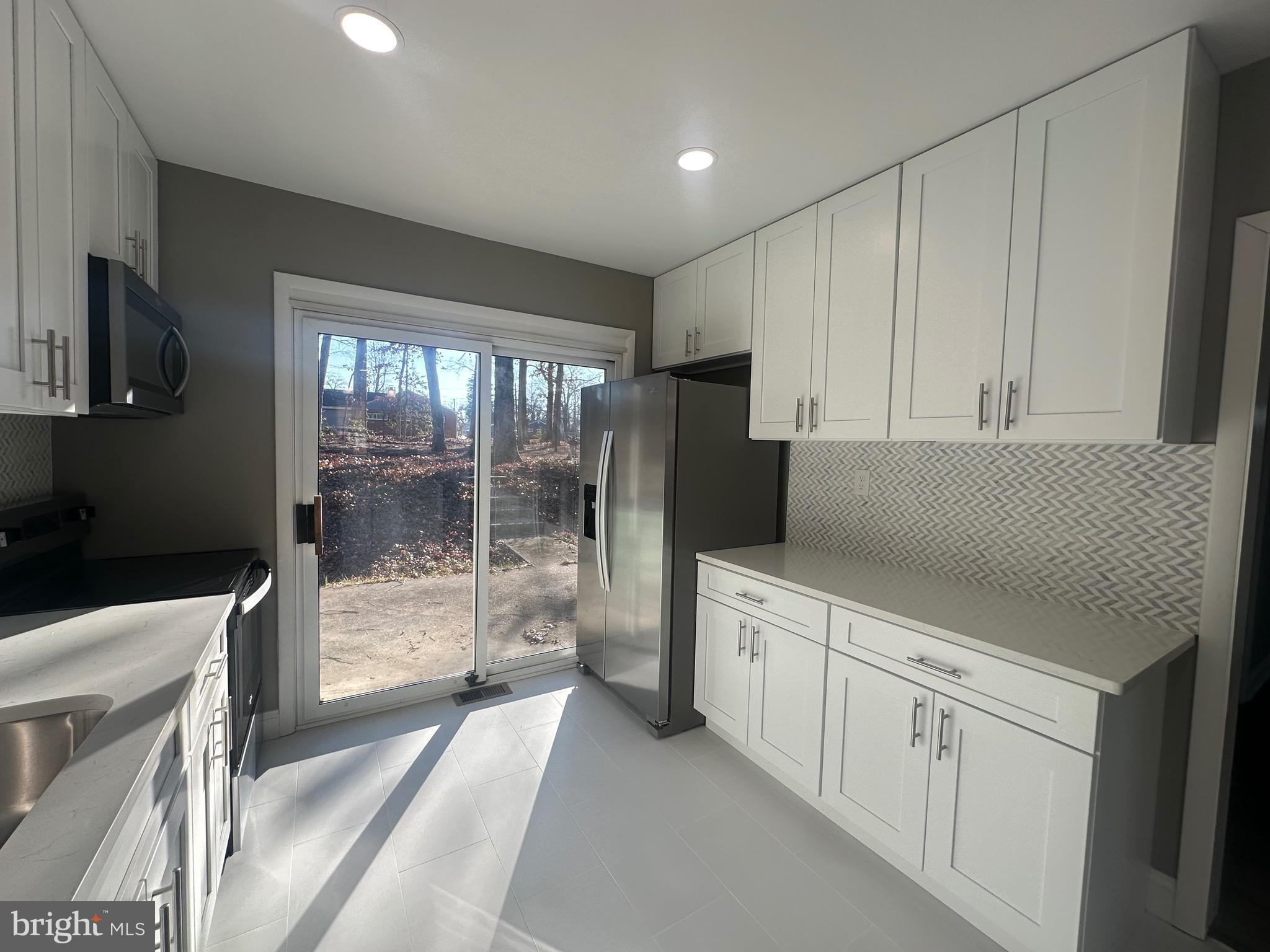 1401 Madison Drive Fort Washington, MD 20744 - Photo 10 of 30 a kitchen with white cabinets and a sink
