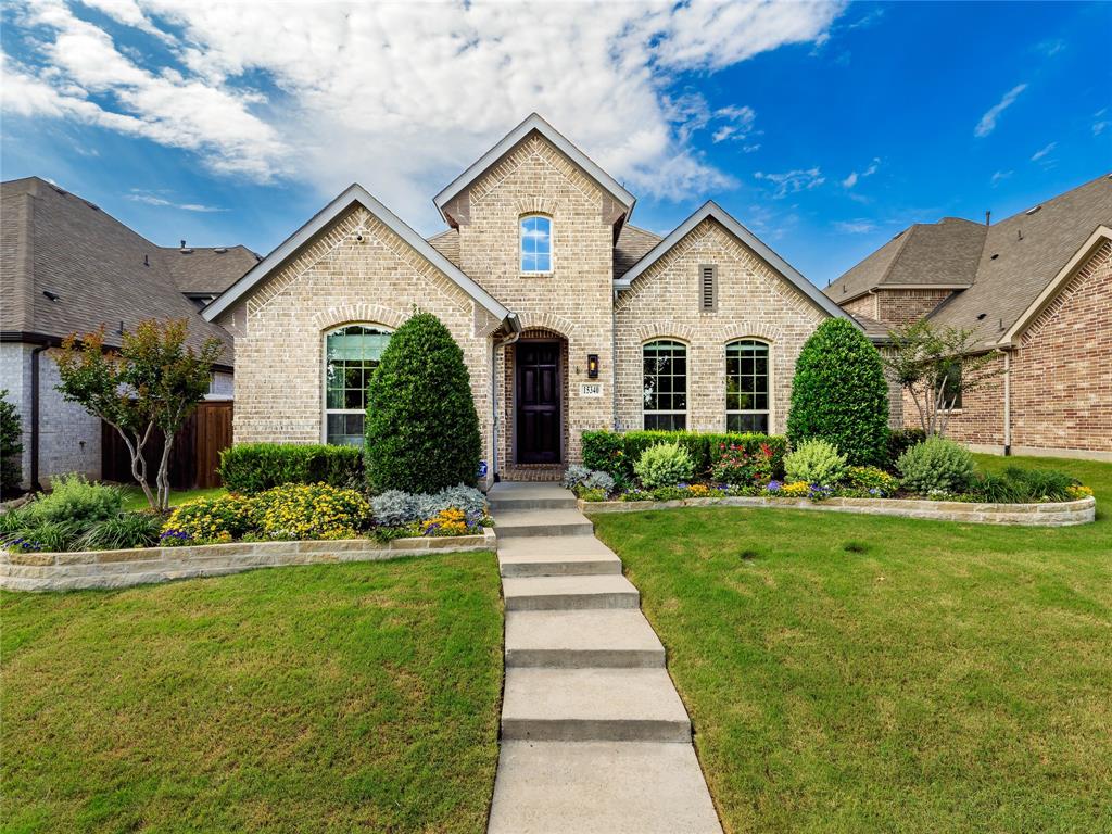 15340 Crape Myrtle Road Frisco, TX 75035 - Photo 36 of 40 Brick facade home featuring a prominent gabled entry, arched windows, and a dark paneled front door
