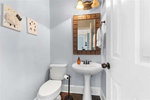 a bathroom with a toilet sink and mirror