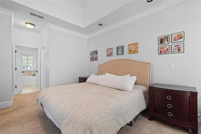 a bedroom with a bed and a night stand