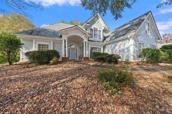 a front view of a house with garden