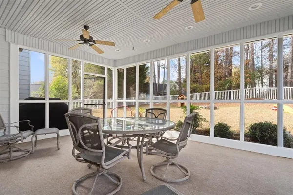 a living room with furniture and large windows
