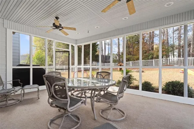 a living room with furniture and large windows