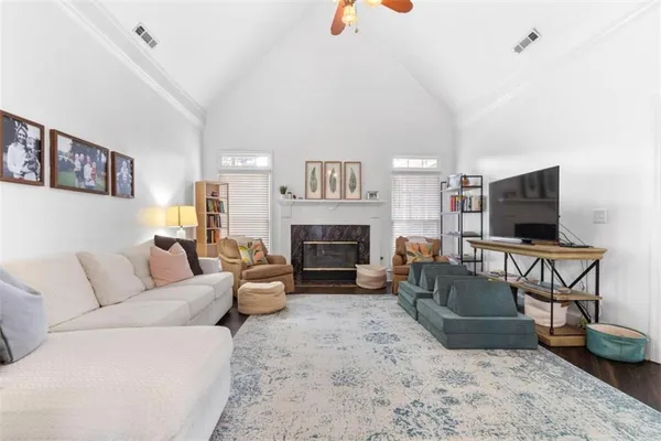 a living room with furniture and a flat screen tv