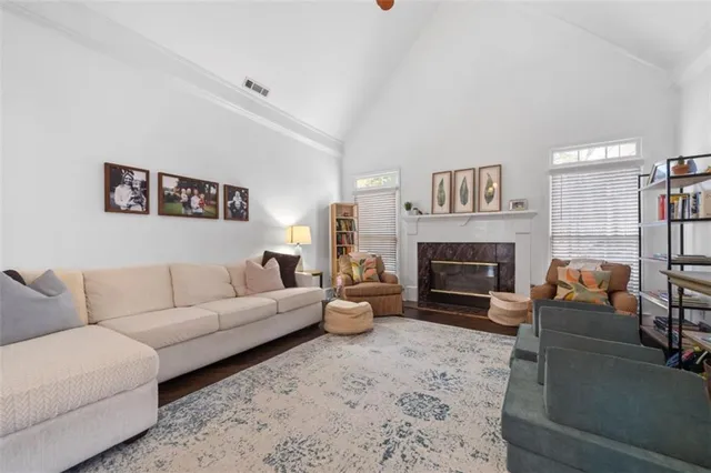 a living room with furniture a fireplace and a large mirror