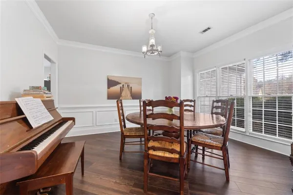 a view of a dining room with furniture and wooden floor
