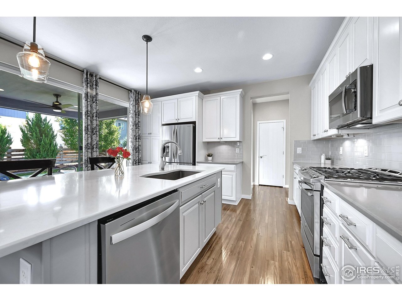 68 Starlight Circle Erie, CO 80516 - Photo 11 of 50 a kitchen with stainless steel appliances granite countertop a sink stove and refrigerator