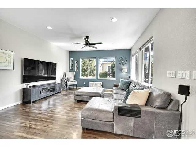 a view with kitchen island a sink and living room view