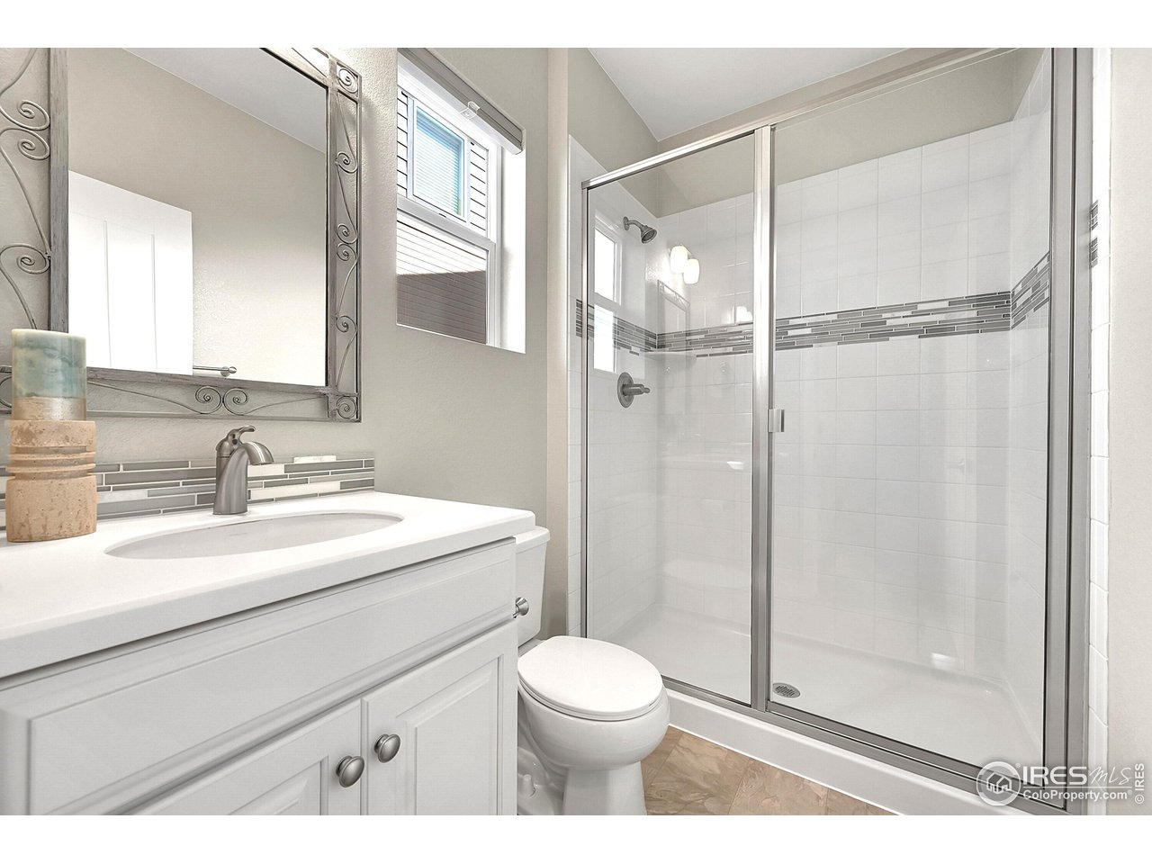 68 Starlight Circle Erie, CO 80516 - Photo 18 of 50 a bathroom with a sink toilet vanity and shower