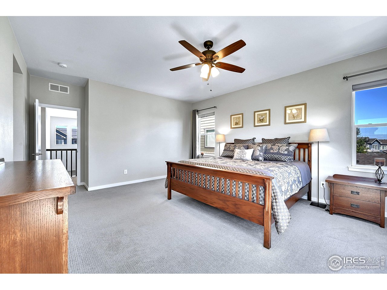 68 Starlight Circle Erie, CO 80516 - Photo 19 of 50 a bedroom with a bed and a chandelier