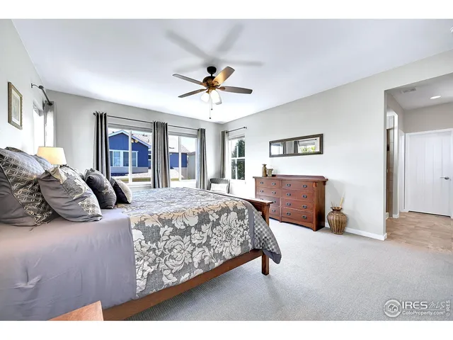 a bedroom with a bed and a table with chair