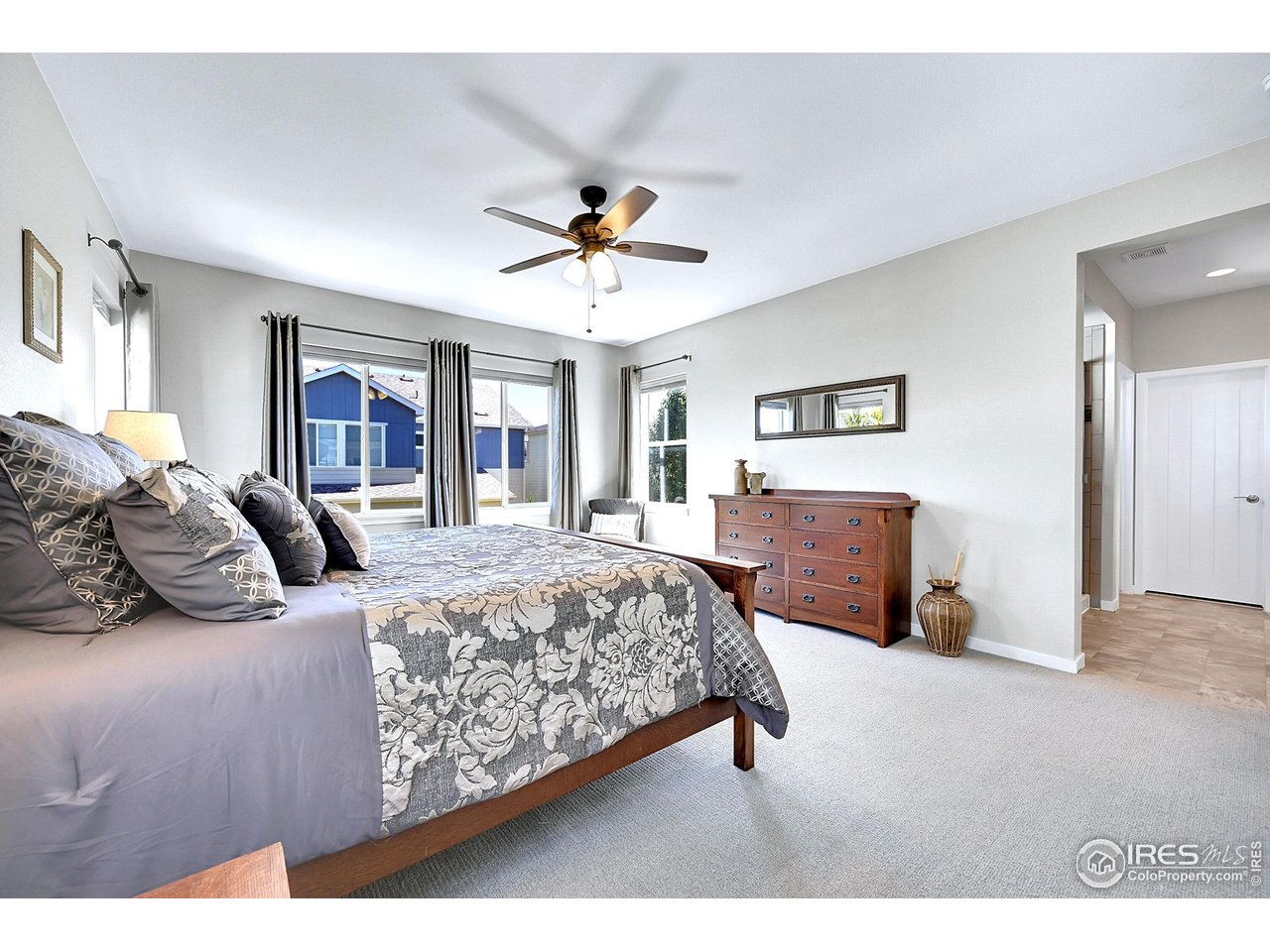 68 Starlight Circle Erie, CO 80516 - Photo 21 of 50 a bedroom with a large bed and a chandelier