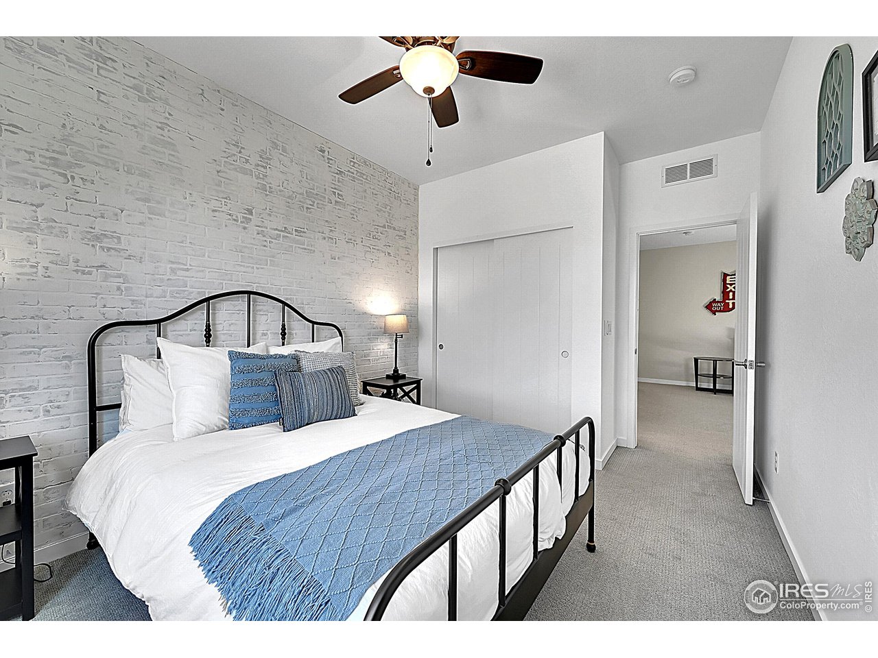 68 Starlight Circle Erie, CO 80516 - Photo 27 of 50 a bedroom with a bed and a chandelier