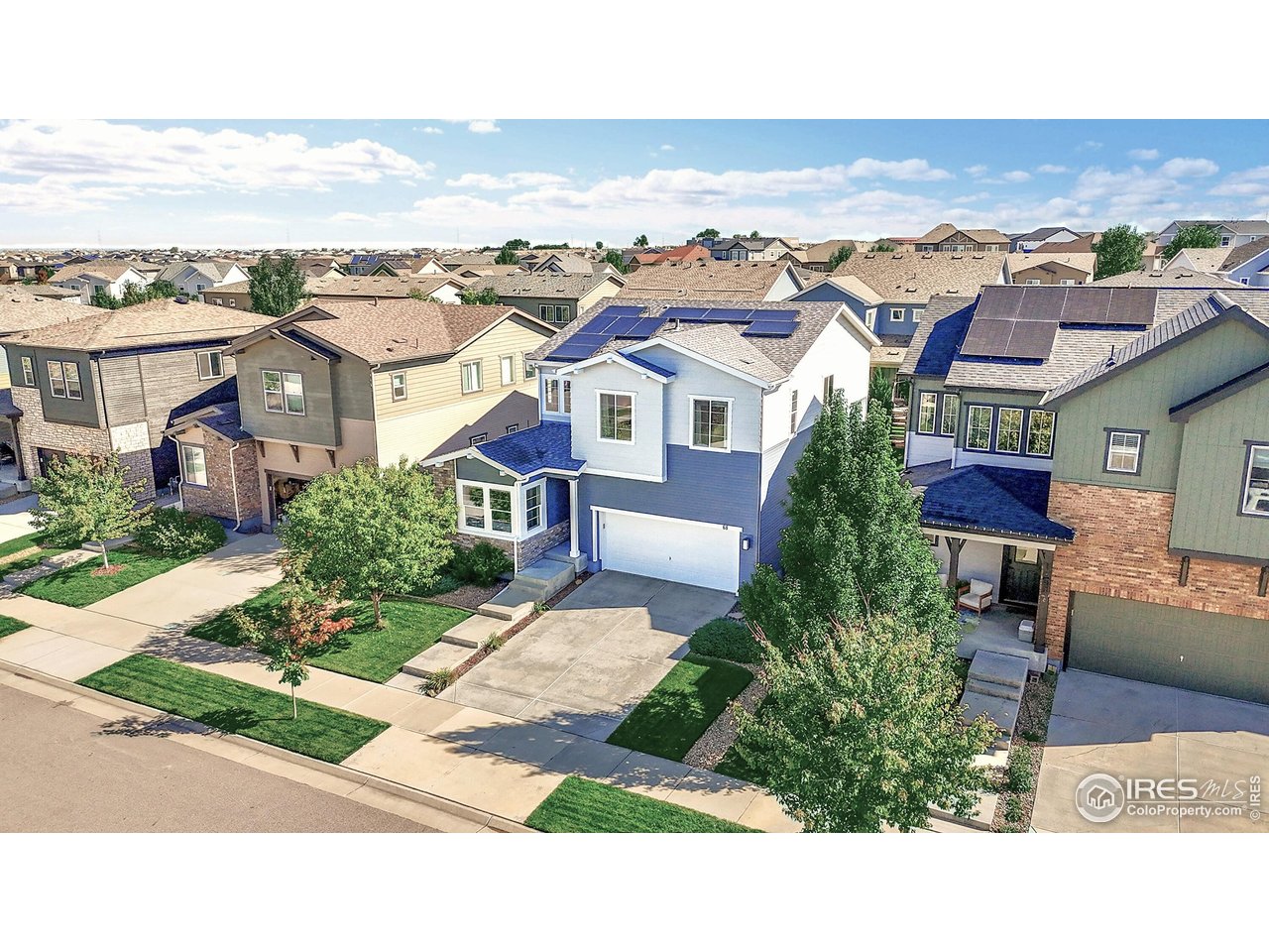 68 Starlight Circle Erie, CO 80516 - Photo 37 of 50 an aerial view of a house with a yard garage and lake view in back