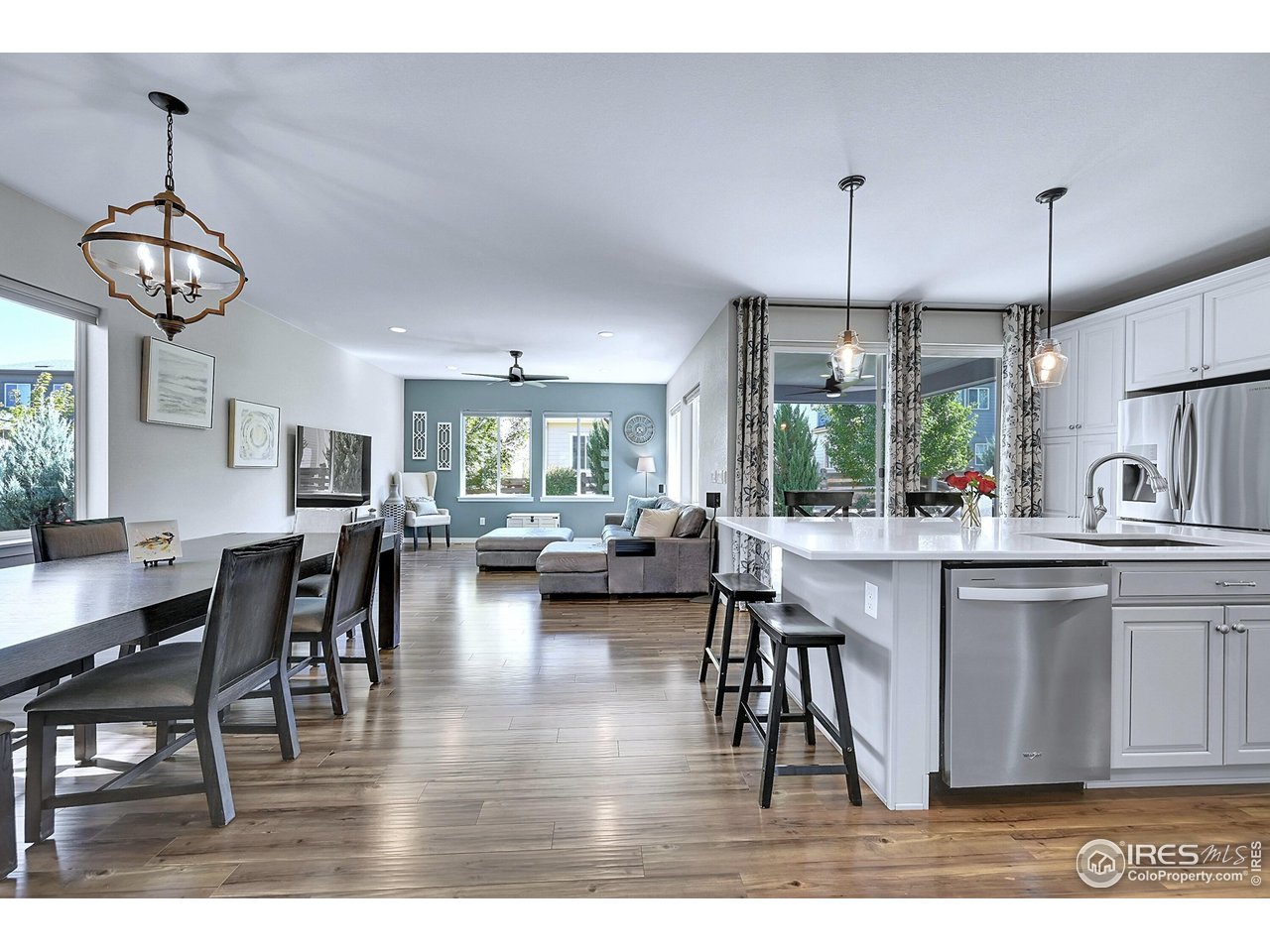 68 Starlight Circle Erie, CO 80516 - Photo 50 of 50 a view of dining room and livingroom with furniture wooden floor a chandelier