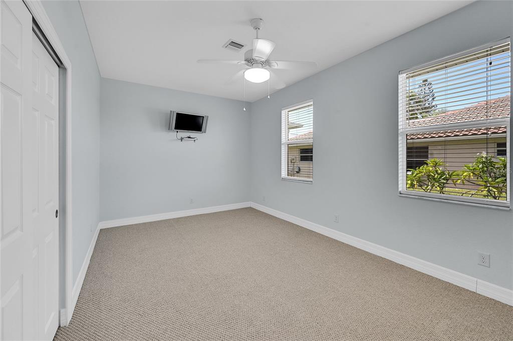 233 Fairway Road Rotonda West, FL 33947 - Photo 19 of 63 wooden floor in an empty room with a window