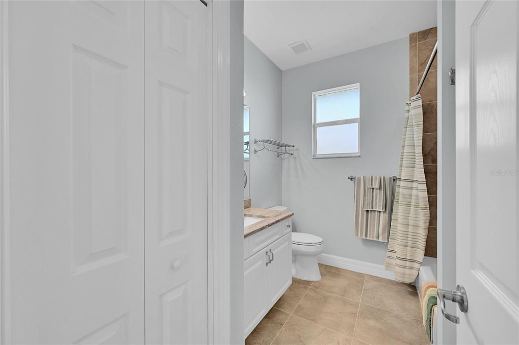 233 Fairway Road Rotonda West, FL 33947 - Photo 25 of 63 a bathroom with a granite countertop toilet a sink and a mirror