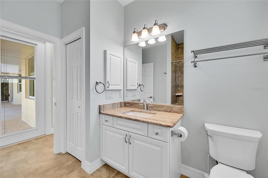 233 Fairway Road Rotonda West, FL 33947 - Photo 26 of 63 a bathroom with a granite countertop sink toilet and mirror
