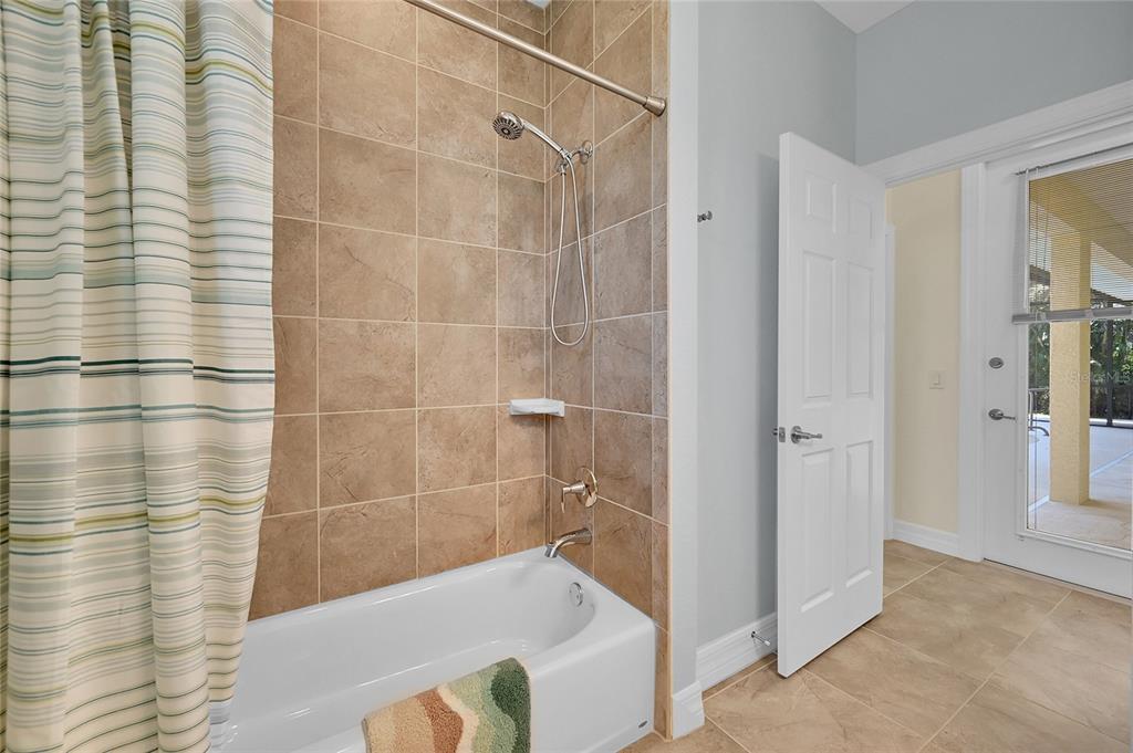 233 Fairway Road Rotonda West, FL 33947 - Photo 27 of 63 a bathroom with a bathtub and shower