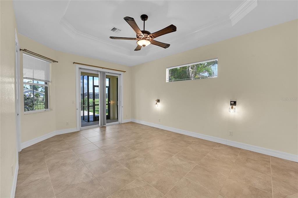 233 Fairway Road Rotonda West, FL 33947 - Photo 28 of 63 an empty room with windows and ceiling fan