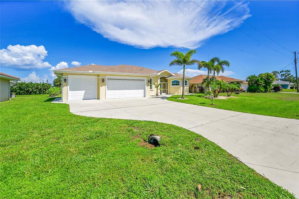233 Fairway Road Rotonda West, FL 33947 - Photo 44 of 63 a front view of a house with garden