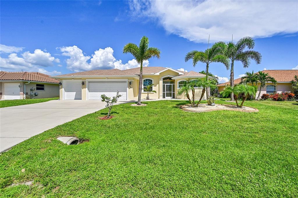 233 Fairway Road Rotonda West, FL 33947 - Photo 45 of 63 a front view of house with yard and green space