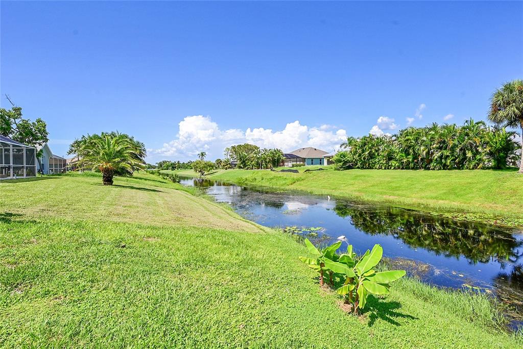 233 Fairway Road Rotonda West, FL 33947 - Photo 49 of 63 a view of a golf course with a lake