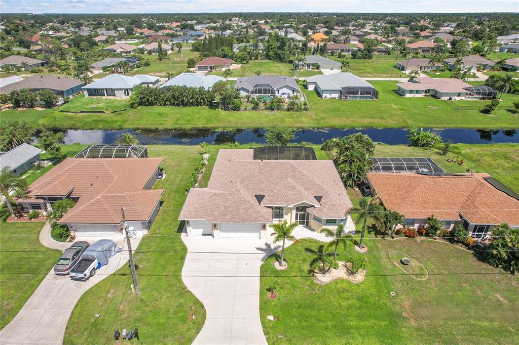 233 Fairway Road Rotonda West, FL 33947 - Photo 53 of 63 an aerial view of a house with a garden and lake view